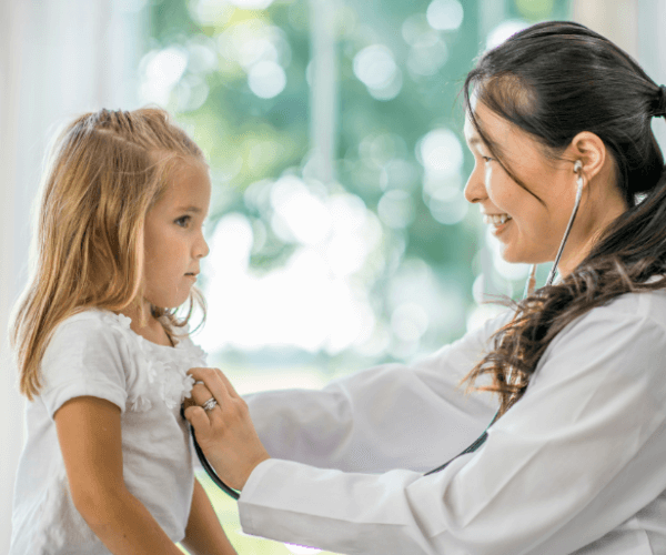 Doctor performing checkup on little girl