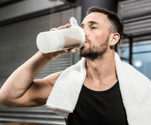 Man drinking protein drink post-workout