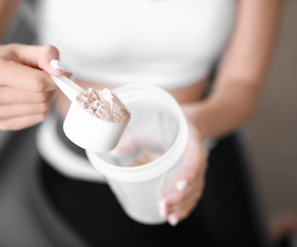 Lady scooping protein powder