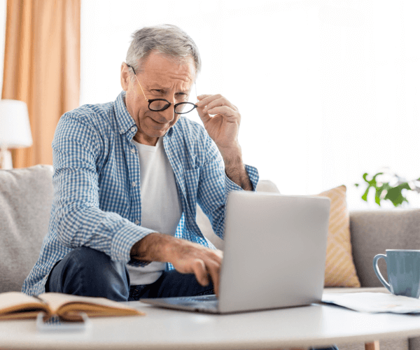 Older gentleman with glasses at laptop